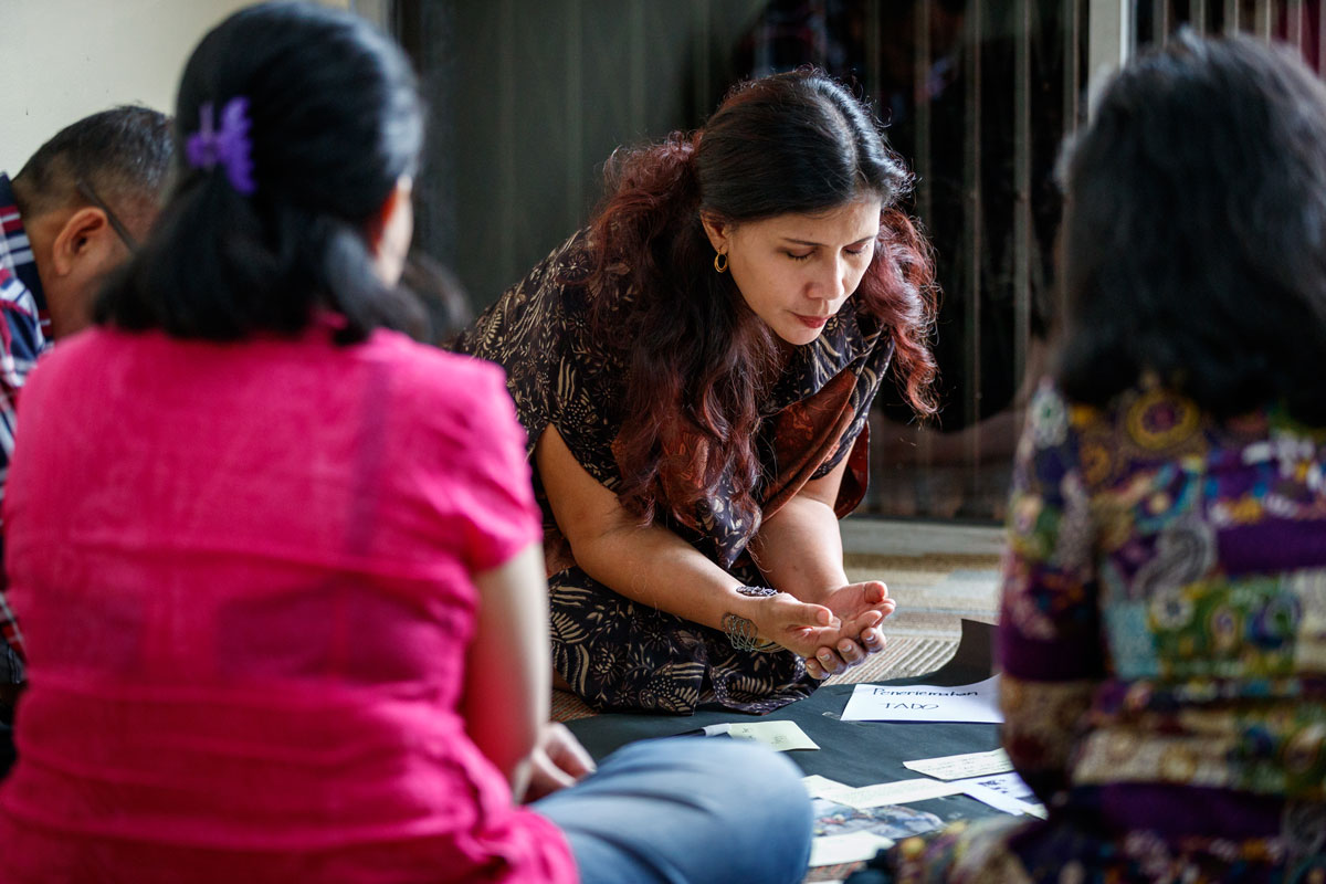 Woman kneeling in prayer.